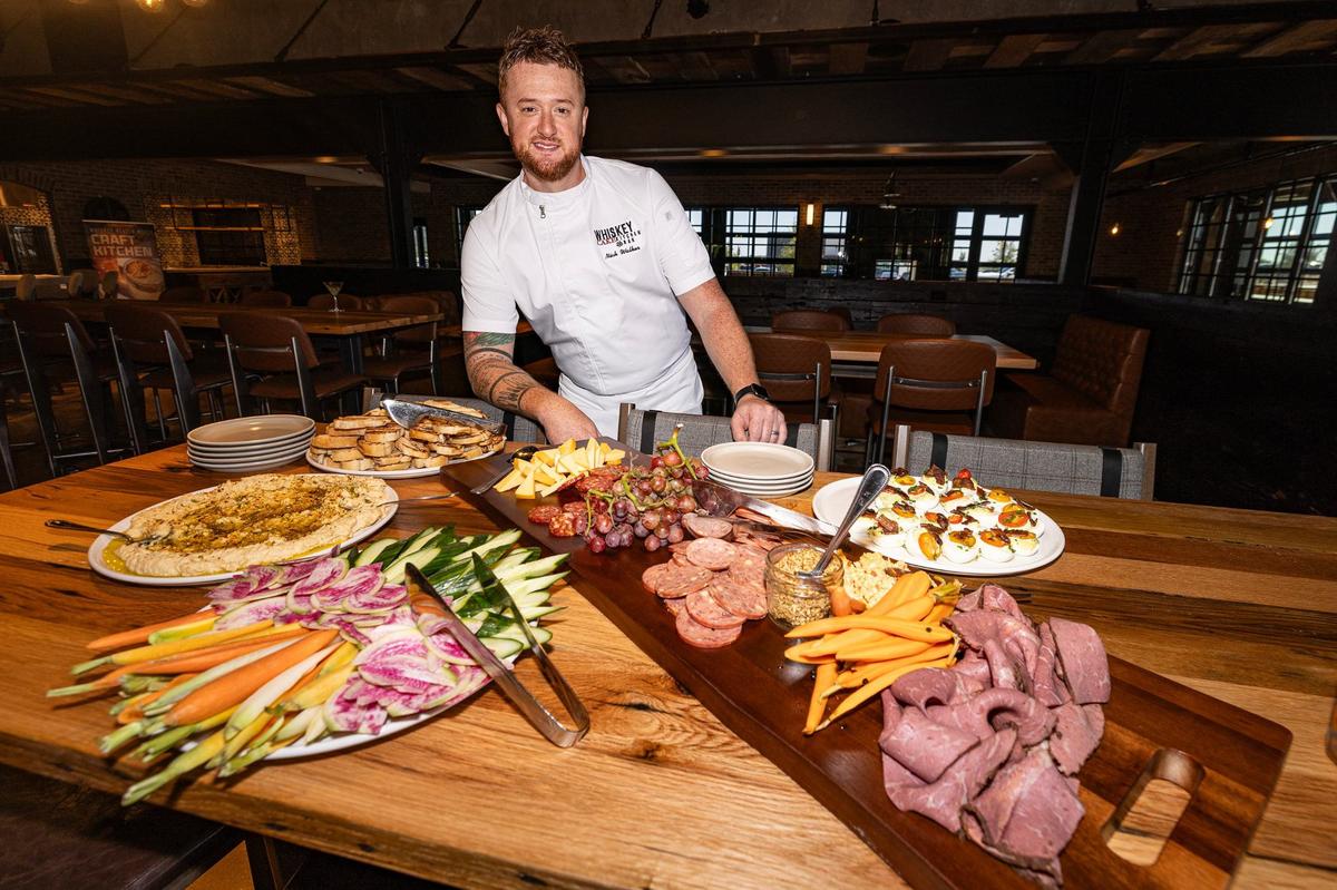 Chef Nick Walker, the Director of Culinary, is photographed with food items from the new Whiskey Cake restaurant in Alliance.