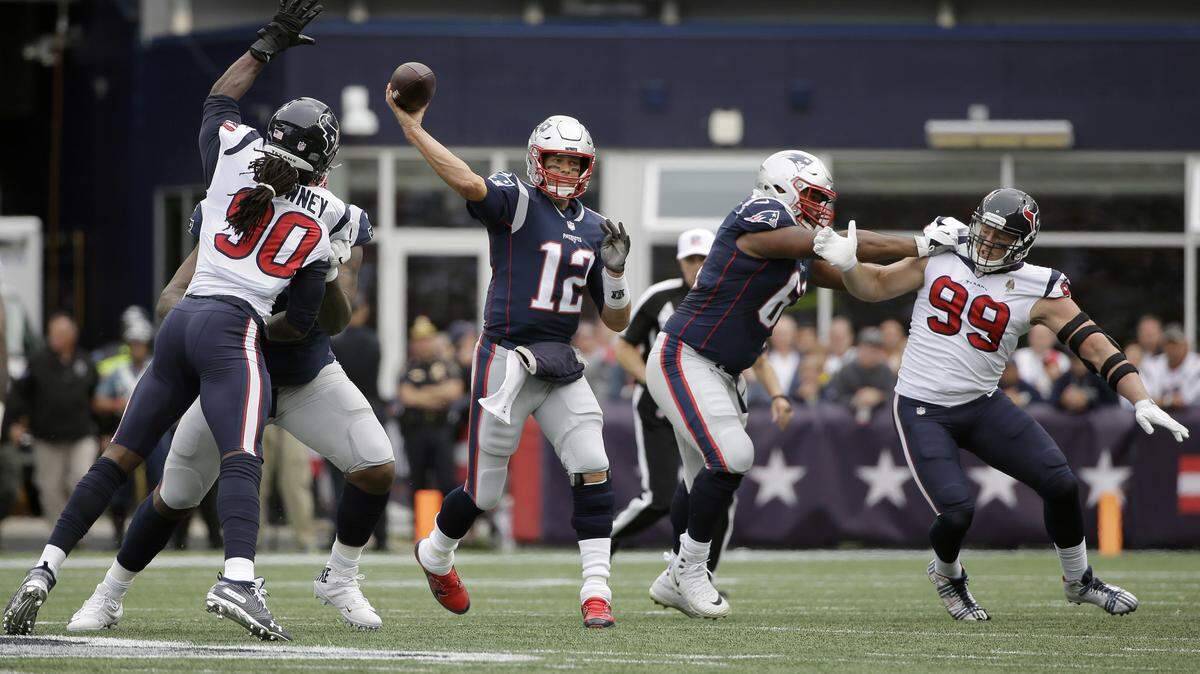 Houston Texans defensive ends Jadeveon Clowney, left, and J.J. Watt, right, pressure the Patriots’ Tom Brady during a game on Sept. 9, 2018, in Foxborough, Mass. Clowney and Watt have combined for seven sacks this season.
