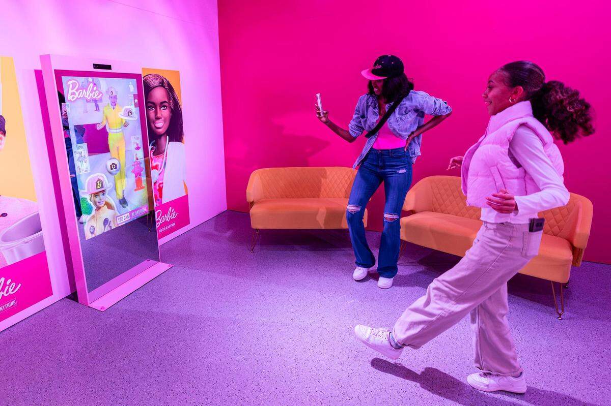 Pressley Jiles tries on different outfits virtually at the Barbie Dream Lounge area at the ‘World of Barbie’ immersive experience at the Stonebriar Centre in Frisco on Thursday, Nov. 16, 2023.