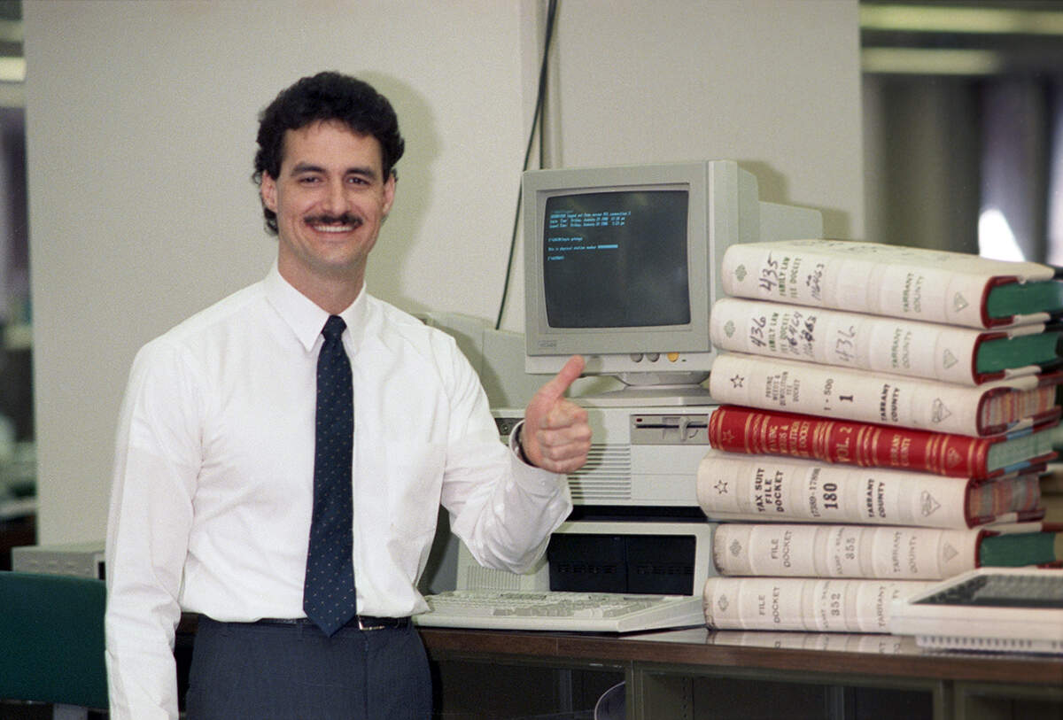 Jan. 29, 1988: First-term Tarrant County District Clerk Tom Hughes with a stack of docket books used to track cases. The 31-year-old, a former General Dynamics systems analyst, was going through the process of computerizing lawsuits and other records. “Eventually,” the Star-Telegram wrote, “the clerk aims to make it possible for lawyers using IBM or IBM-compatible computers to send and receive data direction from their offices. That means lawyers could prepare, file and track their cases by computer.”