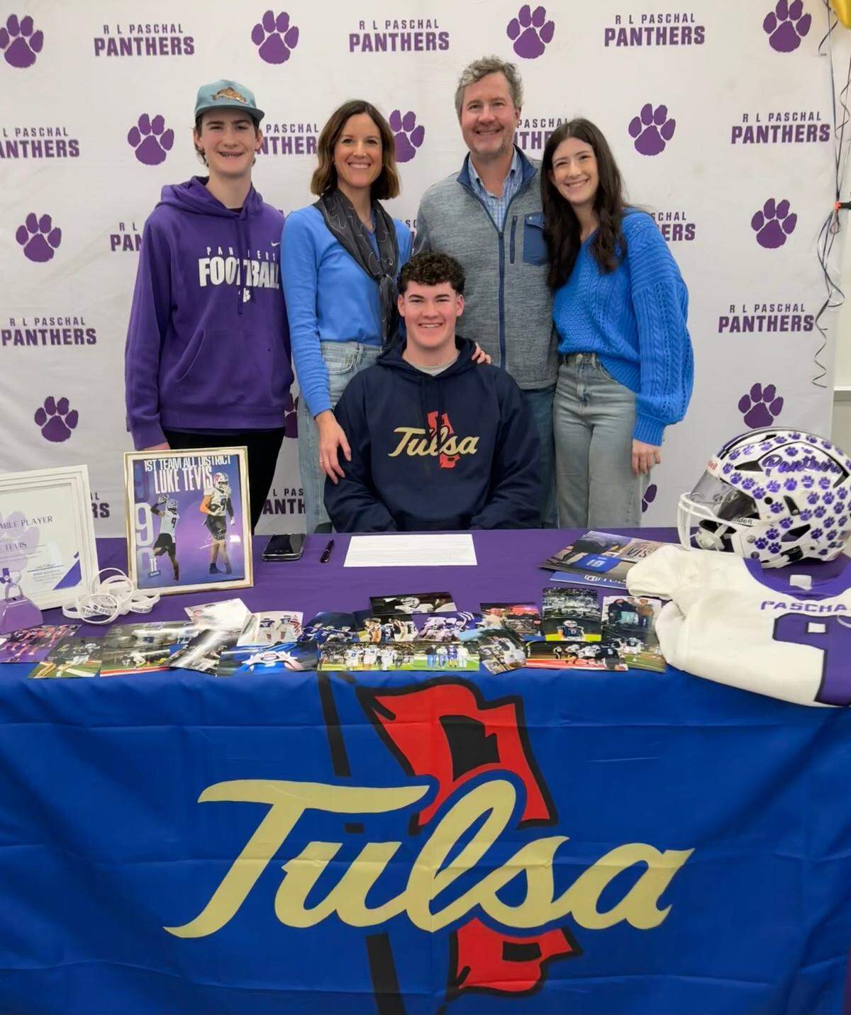 Paschal standout tight end Luke Tevis smiles with siblings Henry and Brooklyn and parents Noah and Whitney after signing with Tulsa football on Wednesday, Feb. 5, 2025.