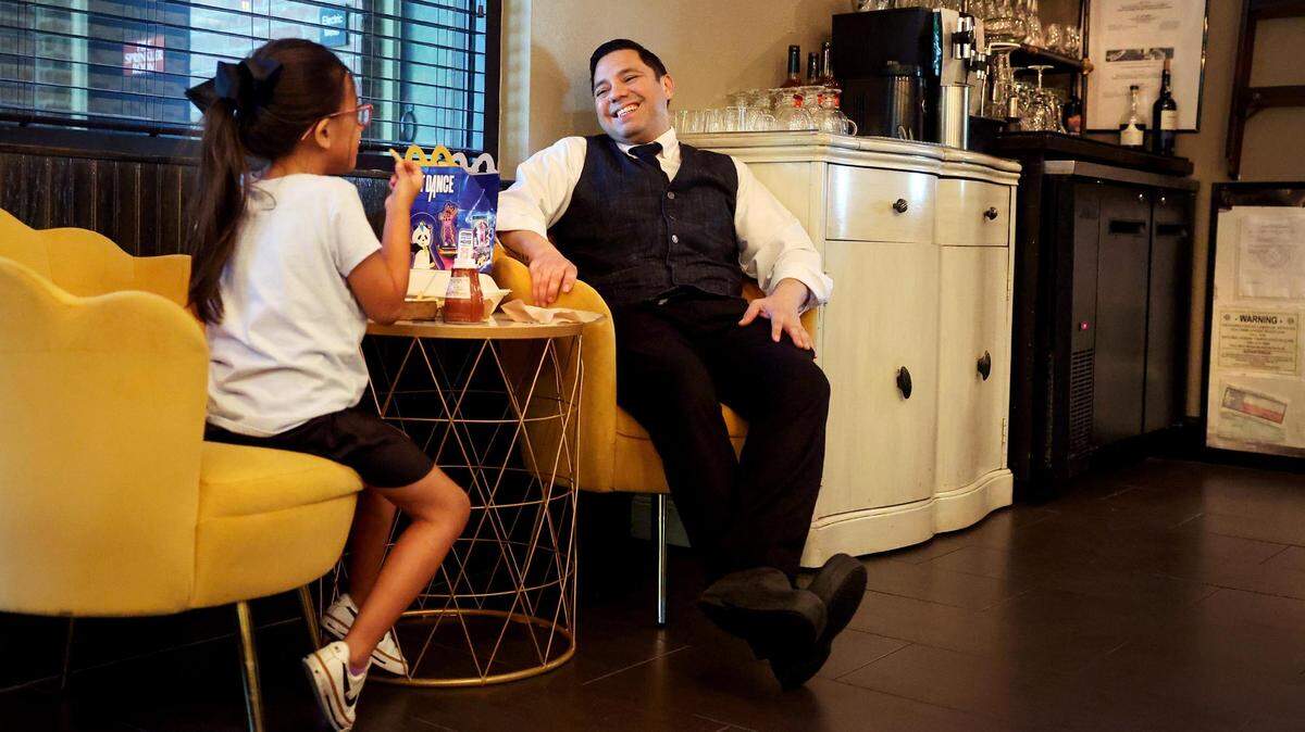 Juan Cordova sits with his daughter, Camila, 6, while waiting for his replacement behind the bar to arrive so he can end his shift at Mac’s on Main restaurant in Grapevine on Friday, April 5. Cordova’s wife, also a restaurant worker, dropped off Camila before heading to her shift.