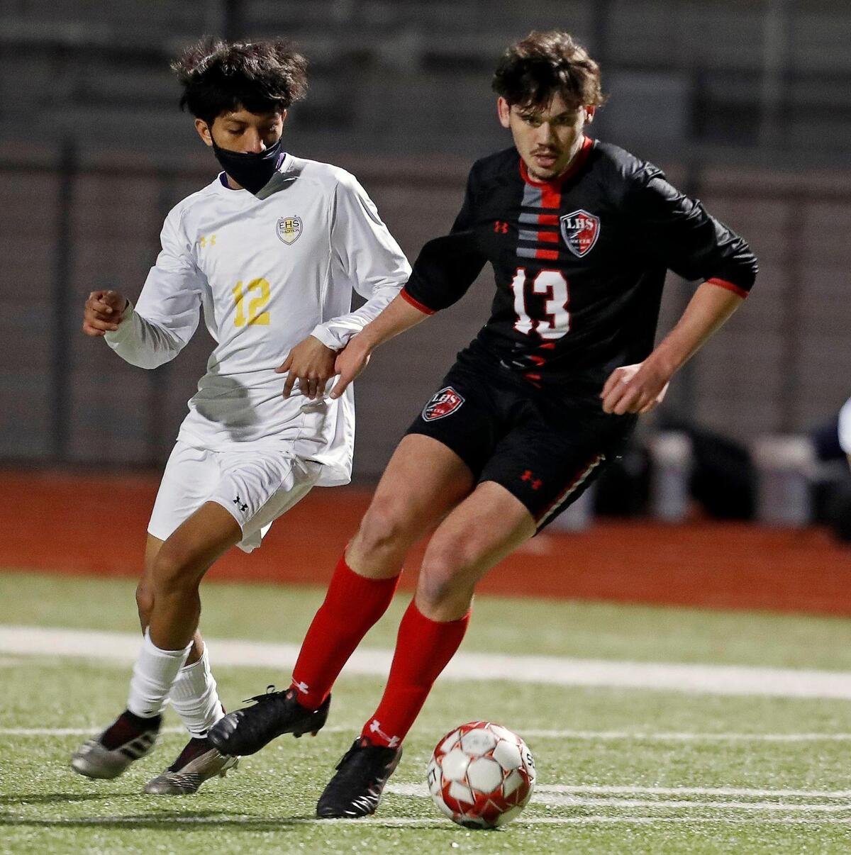 Legacy’s Christopher Chinchilla (13) works the ball away from Everman’s Jaretd Perez (12) during a district 8-5A high school soccer game at Mansfield Legacy High School in Mansfield, Texas, Wednesday, March 03, 2021. Legacy defeated Everman 5-1. (Special to the Star-Telegram Bob Booth)