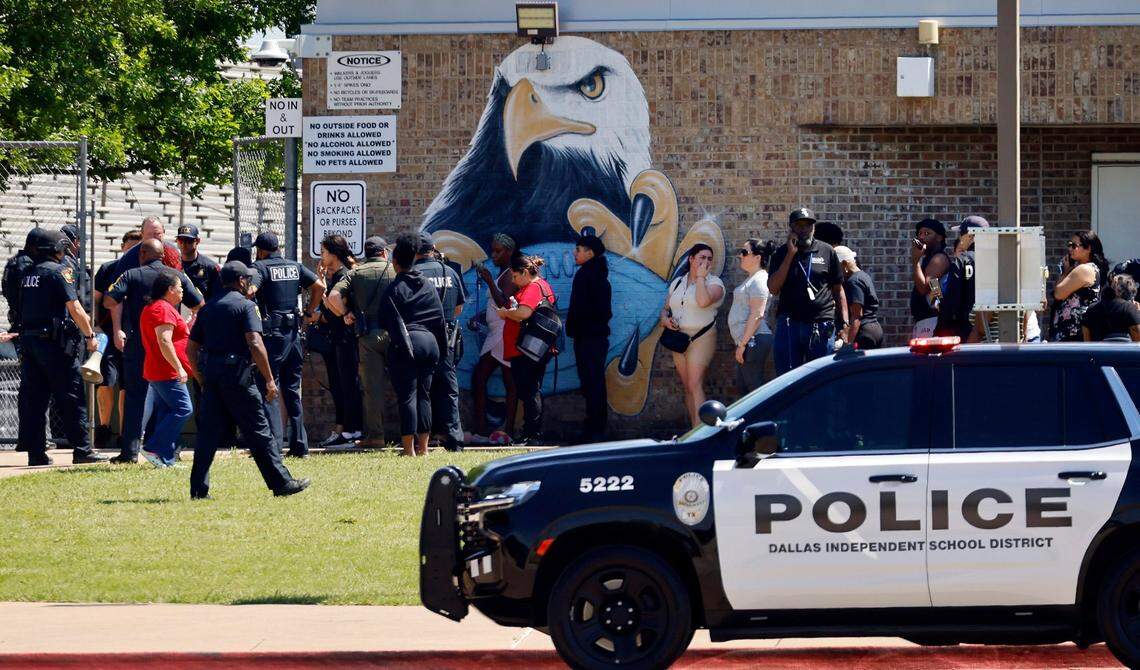 Parents of Wilmer-Hutchins High School students wait to pick up their children from the school stadium following a shooting inside the Dallas school on Tuesday, April 15, 2025.