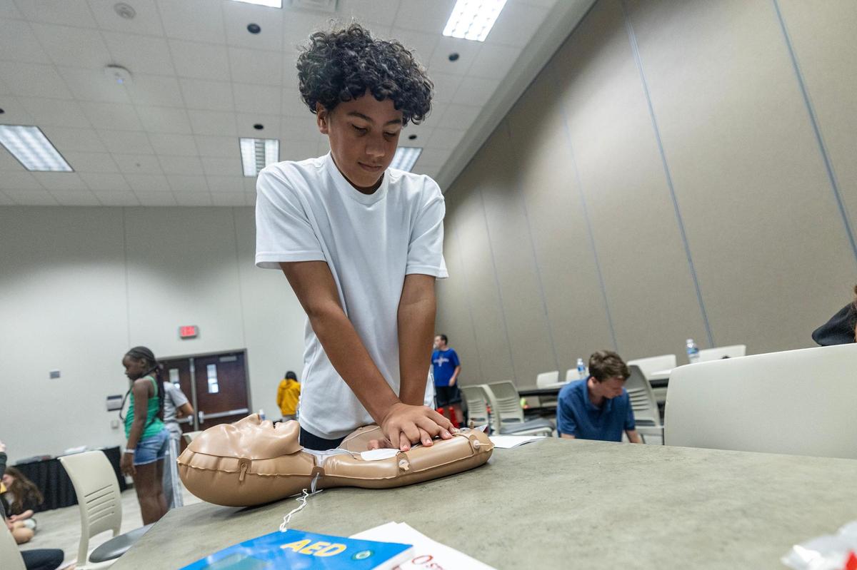 Rodrigo Perez, 13, practices how to do chest compressions during a CPR class at the Pat May Center in Bedford on Tuesday, Oct. 29, 2024.