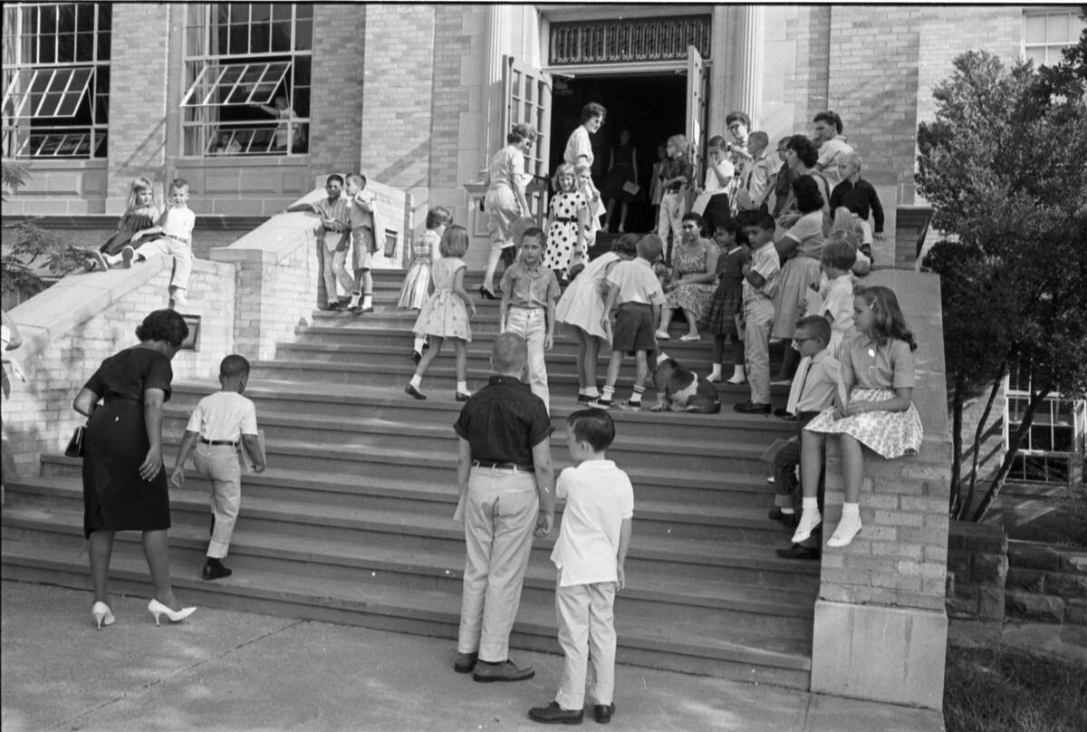 Sept. 5, 1963: Front steps of Lily B. Clayton Elementary School when the first African-American student enrolled in the all-white school. Kenneth Ray Blakey, age 6, is accompanied by his mother Connie Blakey as they enter the school on the first day.