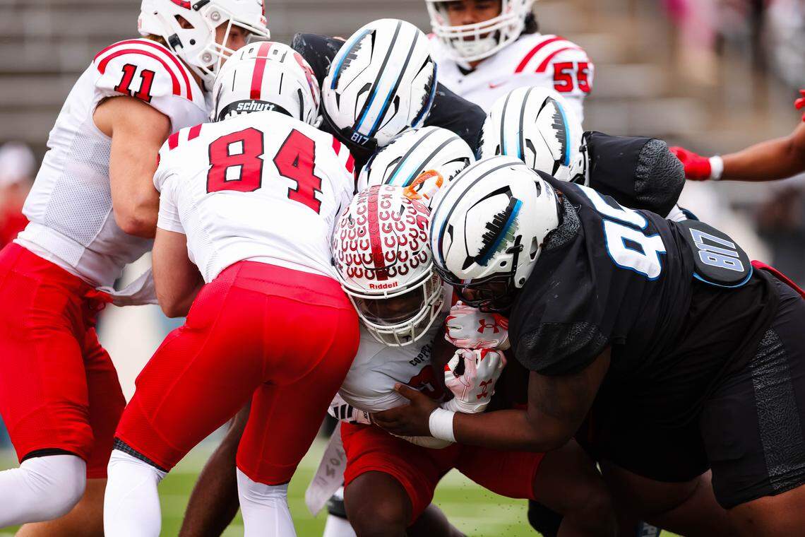 Multiple North Crowley defenders make a tackle on a Coppell running back during a Class 6A Division I regional playoff Saturday, Nov. 29, 2025, at Midlothian ISD Stadium in Midlothian.