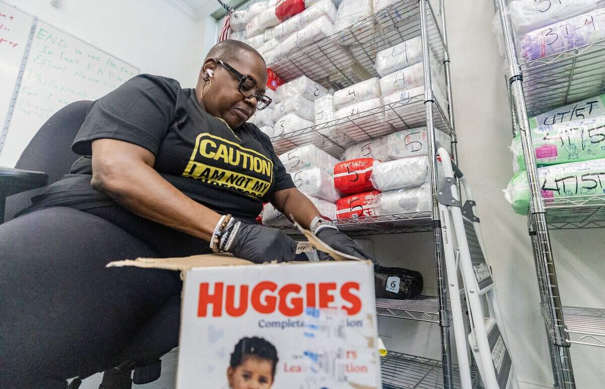 Staff member "D" Evans opens a box of diapers at the Community Food Bank of Fort Worth on June 15, 2026. The Community Food Bank also provides families with clothing, pet food and cleaning supplies.