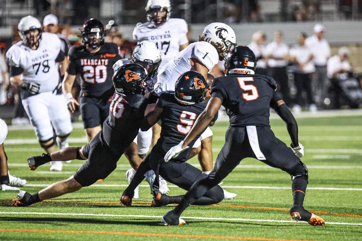 Denton Guyer’s Kaedyn Cobbs is tackled by Aleldo’s Cole Cox (16), Kamron Hall (9) and Jordan Hall in a game at Tim Buchanan Stadium on Friday, Aug. 29, 2025.