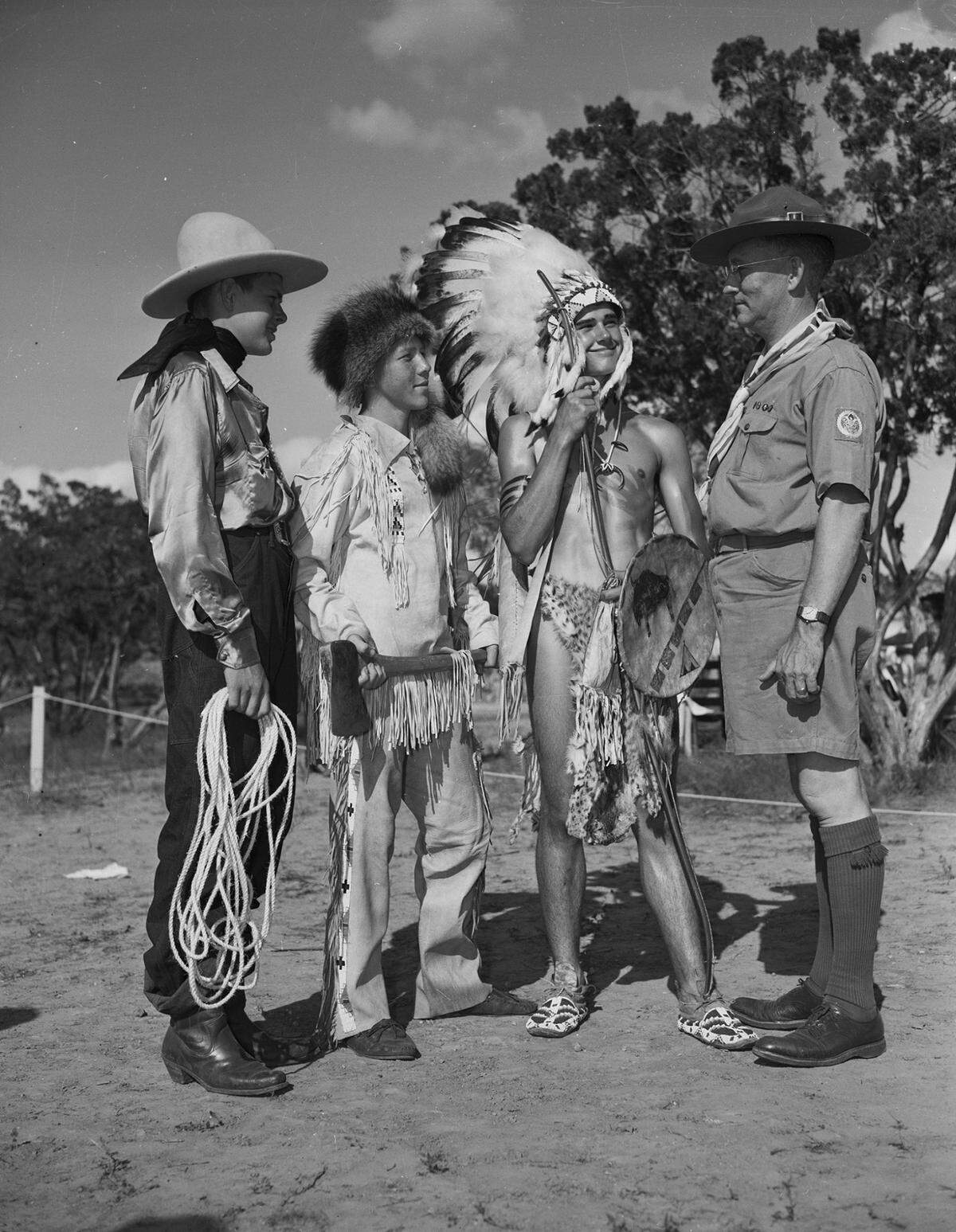 June 23, 1940: At the re-dedication ceremony of Worth Ranch, Boy Scout camp in Palo Pinto County, Scout Commissioner D.H.B. Todd, far right, inspects the pageant costumes of three scouts, from left, Charles Moore, of Arlington, dressed as a cowboy, Earl Finkle of Arlington Heights, Fort Worth, dressed as a woodsman, and George Dickey of Arlington, dressed in Native American attire.