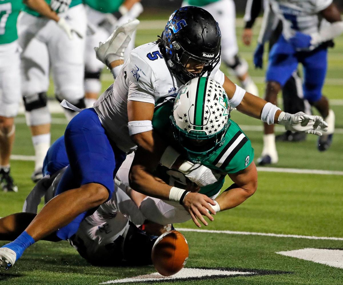 Southlake Carroll running back Owen Allen (2) fumbles the ball as he is tackled by Byron Nelson’s Ashton Williams (5) in the first half of a District 4-6A football game at Dragon Stadium in Southlake, Texas, Friday, Oct. 28, 2022. Carroll led Byron Nelson 21-13 at the half. (Special to the Star-Telegram Bob Booth)