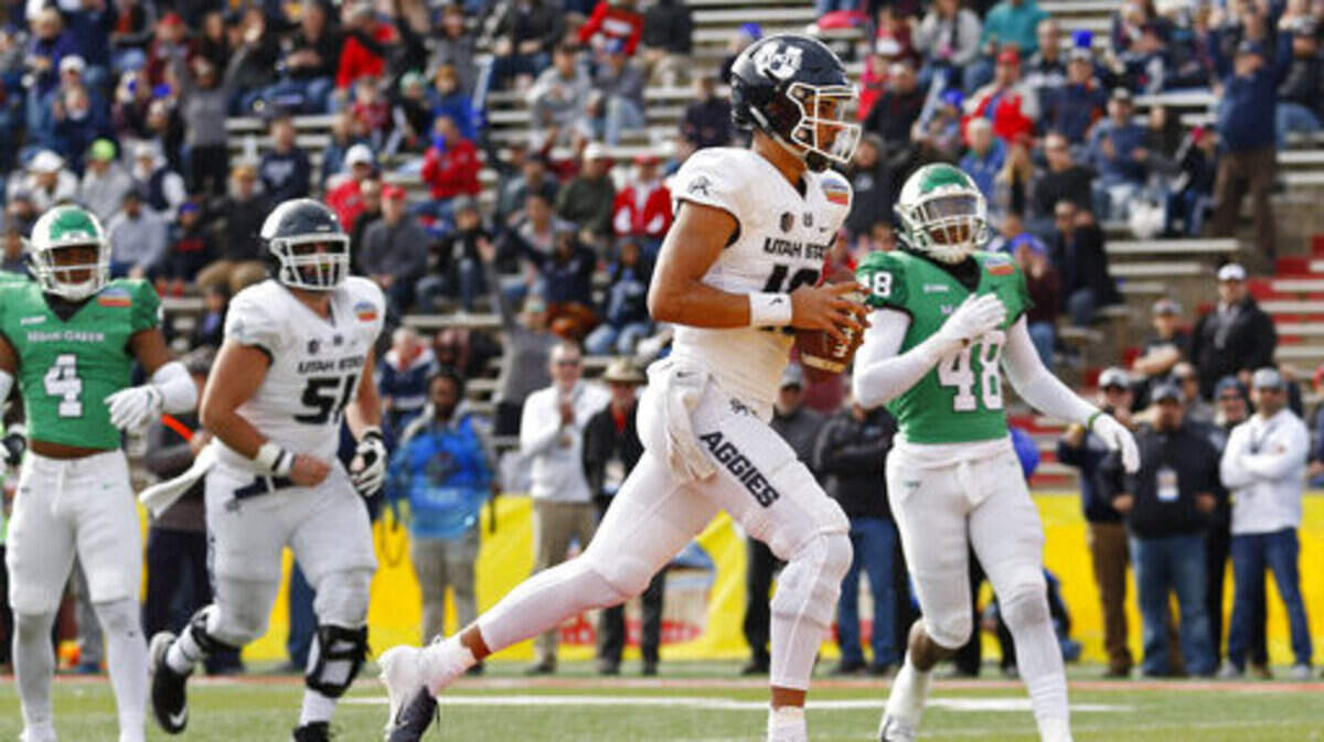 Utah State quarterback Jordan Love (10) scores a touchdown against North Texas during the first half of the New Mexico Bowl NCAA college football game in Albuquerque, N.M., Saturday, Dec. 15, 2018. (AP Photo/Andres Leighton)