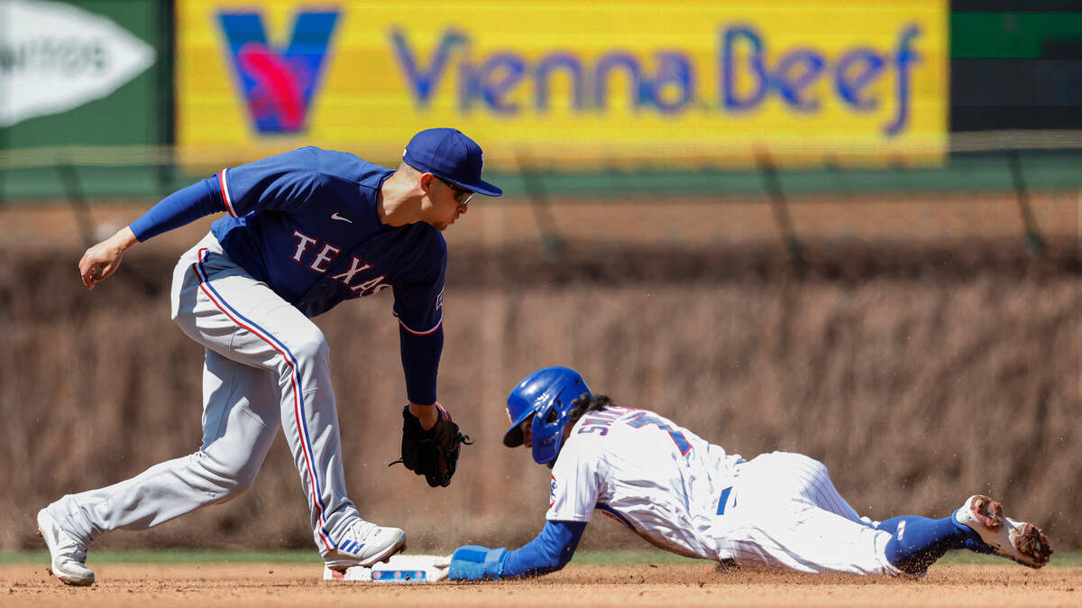Chicago Cubs' Dansby Swanson (7) steals second base against Texas Rangers shortstop Corey Seager (5) on Friday at Wrigley Field. 