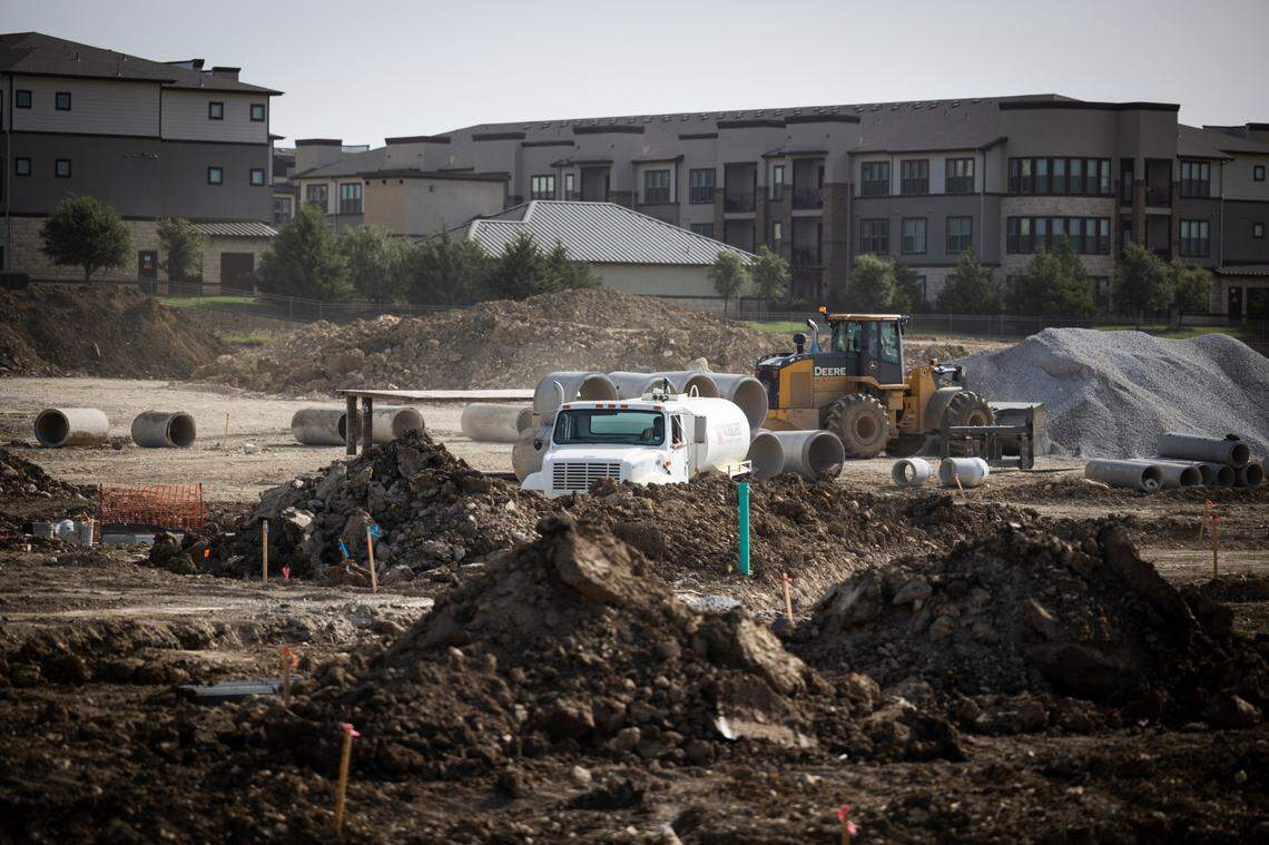 A bulldozer and other construction equipment are shown working amid piles of dirt on cleared land where a shopping center is being built in north Fort Worth along Heritage Trace Parkway. This is near where Fort Worth’s first H-E-B grocery store is expected to be built.