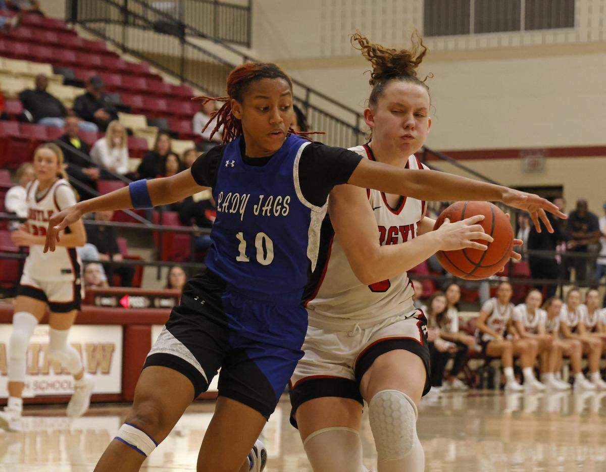 Mansfield Summit guard Kyleigh Smith (10) attempts to block the net from Argyle guard Wrigley Green (5) during the first half of a UIL Class 5A DII girls playoff basketball game at Saginaw High School in Saginaw, Texas, Thursday Feb. 19, 2026.