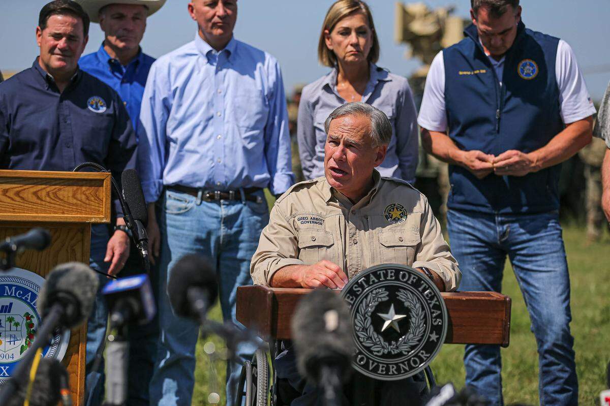 Gov. Greg Abbott, backed by other Republican governors, Texas National Guard leaders, and law enforcement officers, speaks at a press conference on the U.S. southern border in Mission, Texas, on Oct. 6, 2021.