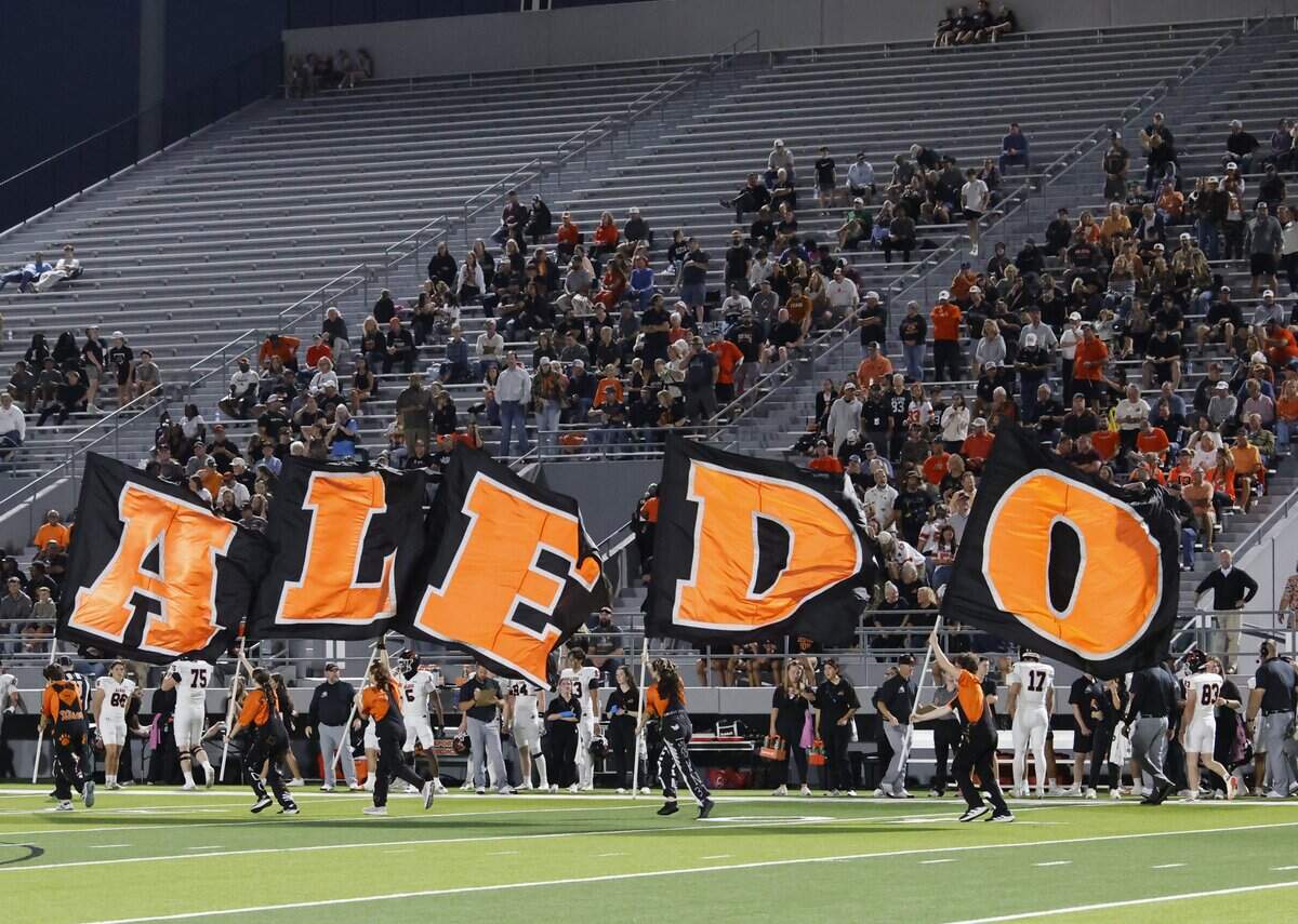 The Aledo flag runners celebrate a touchdown during the first half of a UIL football game against North Richland Hills Richland on Thursday, October, 23, 2025 at Birdville FAAC Stadium in North Richland Hills, Texas.