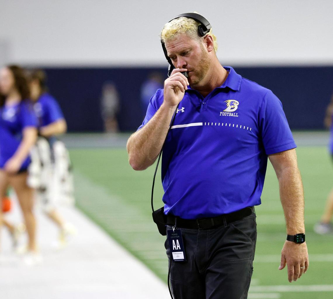 Brock head coach Billy Mathis talks to the upstairs coaches late in the second quarter of a UIL Conference 3A Division 1 semifinal playoff football game at The Ford Center in Frisco, Texas, Thursday, Dec. 07, 2023.