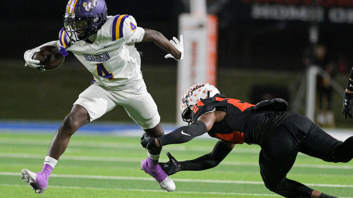 Richardson wide receiver Dameon Crowe (4) avoids a tackle by Haltom defensive back Andre Rich (24) during a UIL bi-district playoff football game against Haltom at Birdville ISD Fine Arts/ Athletic Complex in North Richland Hills, Texas on Friday, Nov. 15, 2024.