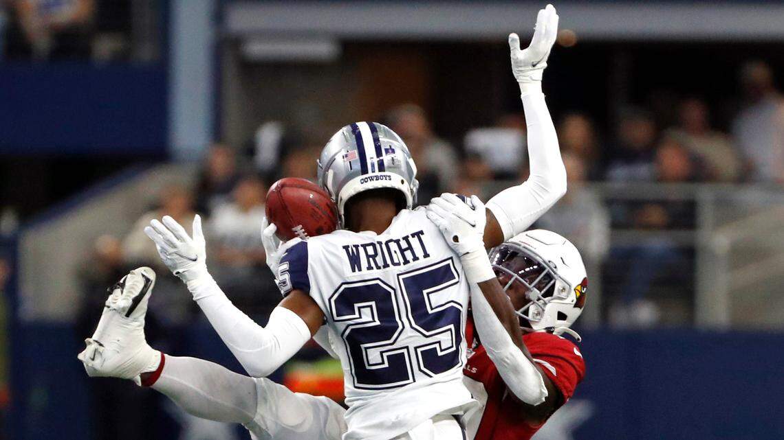 Dallas Cowboys cornerback Nahshon Wright hits Arizona Cardinals running back Jonathan Ward as he reaches to catch a pass on a fake punt in the first half Sunday at AT&T Stadium.
