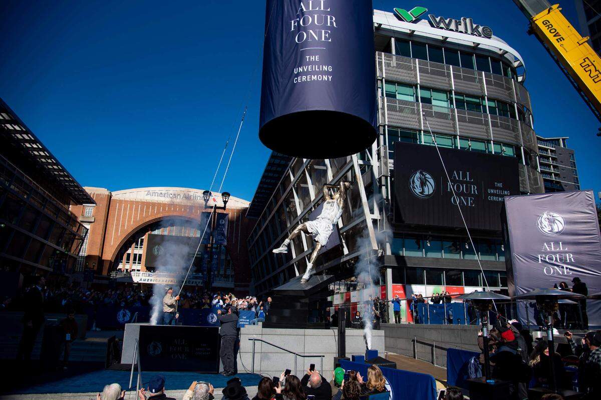 Dirk Nowitzki’s statue is unveiled during the “All Four One” statue ceremony in front of the American Airlines Center in Dallas, Sunday, Dec. 25, 2022. (AP Photo/Emil T. Lippe)