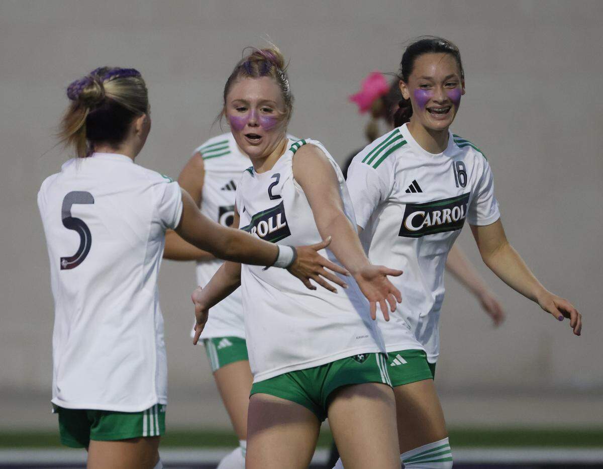 Southlake Carroll midfielder Macie Colvin, midfielder Audrey Anderson (5) and forward Tori Stovall celebrate after Anderson scored during the second half of a UIL bi-district round soccer playoff game at Crowley ISD Multi-Purpose Stadium in Fort Worth, Texas, on Friday, March 20, 2026.