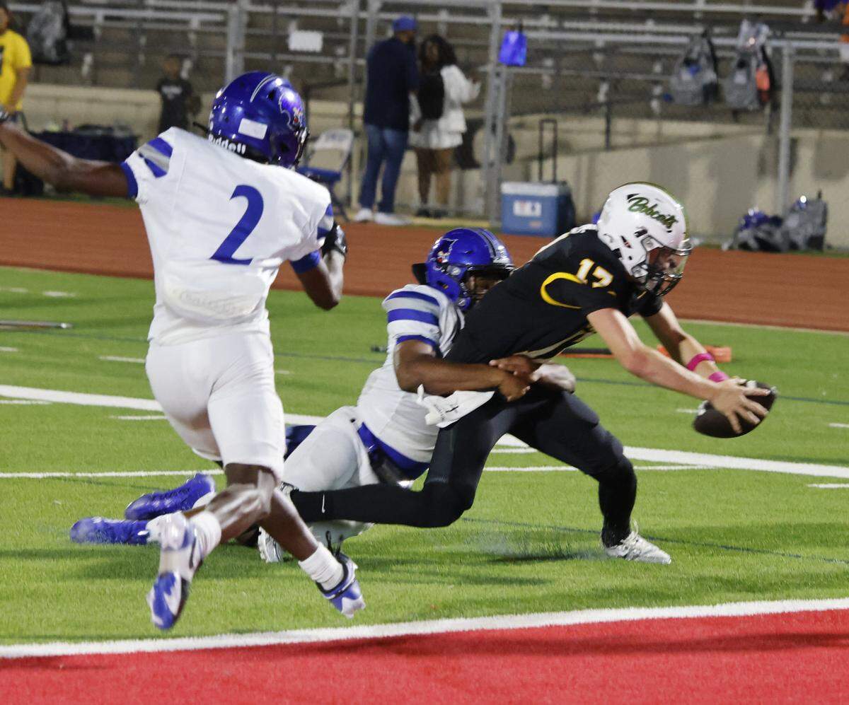 Benbrook quarterback Brennan Barton (17) reaches for the goal line during the second half of a UIL football game between Benbrook and Dunbar at Herman E. Clark Stadium in Fort Worth, Texas, Friday, October 10, 2025.