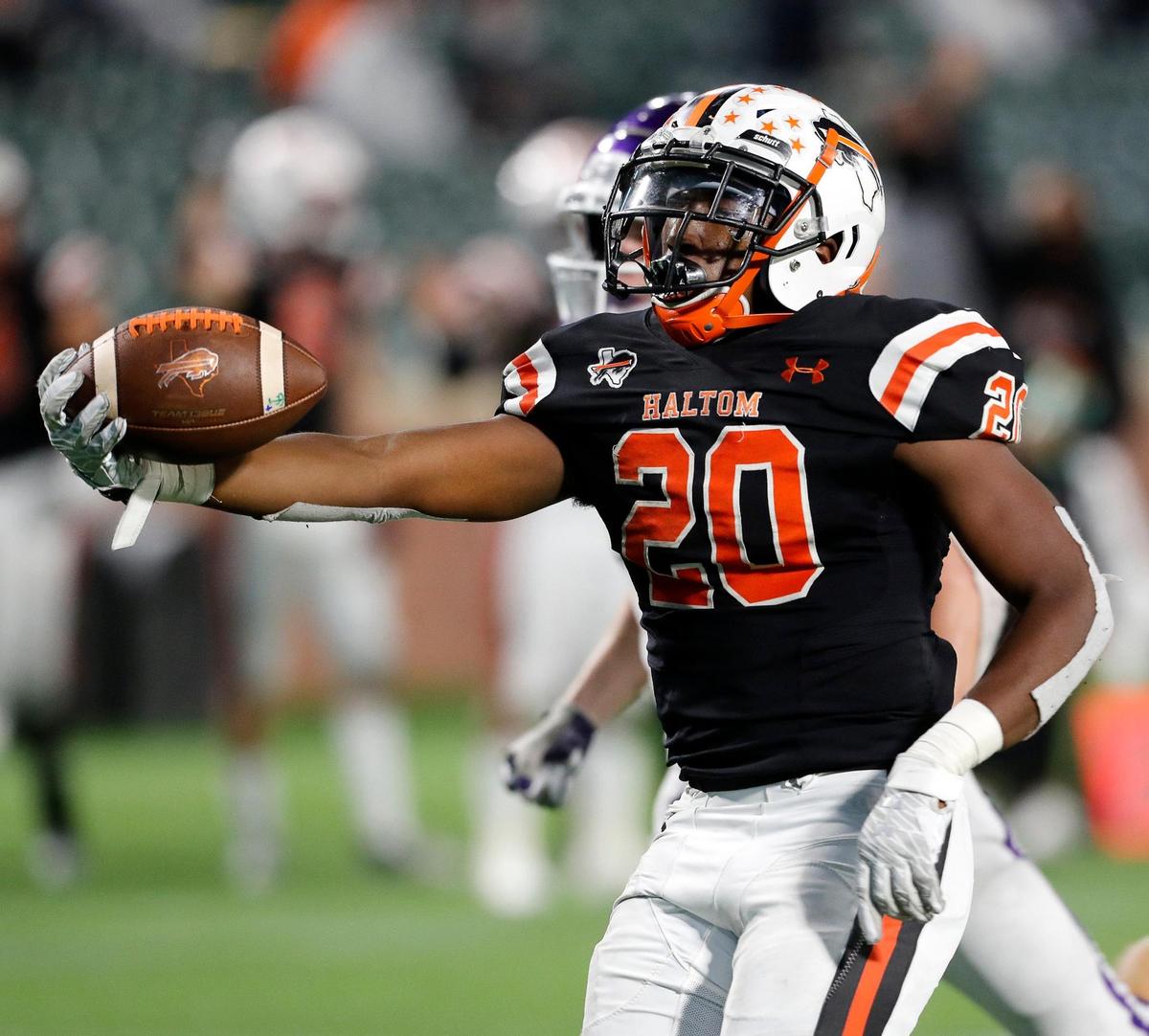 Haltom running back A.J. Reynolds (20) extends the ball as he crosses the goal line during a high school football game at Globe Life Park in Arlington, Texas, Thursday, Nov. 12, 2020. Haltom defeated Paschal 51-7. (Special to the Star-Telegram Bob Booth)