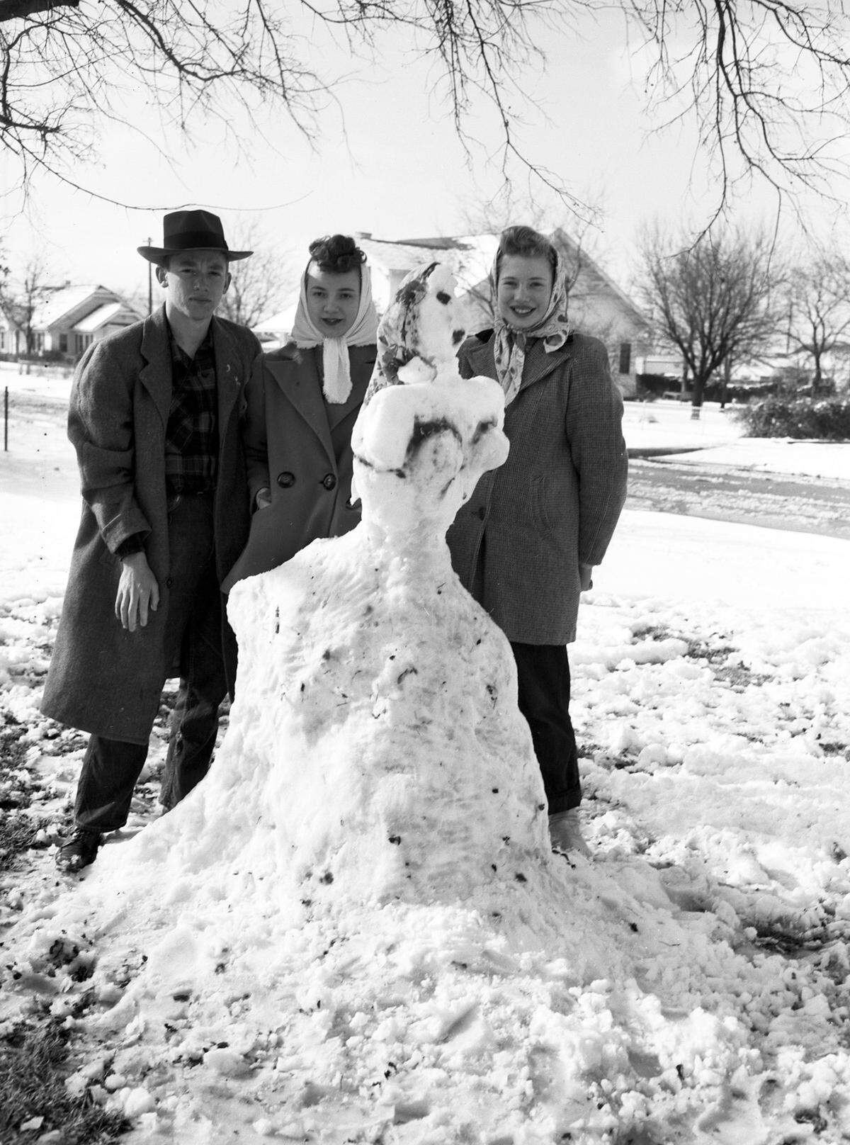 March 7, 1947: “Ray Baldwin, Joan Moore, and Peggy Mize standing beside snowman.”