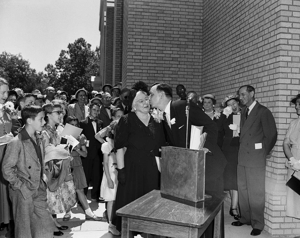 April 27, 1952: The Rev. H. Guy Moore plants a birthday kiss on Mrs. Maude Williamson, church secretary for 29 years, while they fill a time capsule. For her birthday, she wore an orchid corsage, gift of the church.