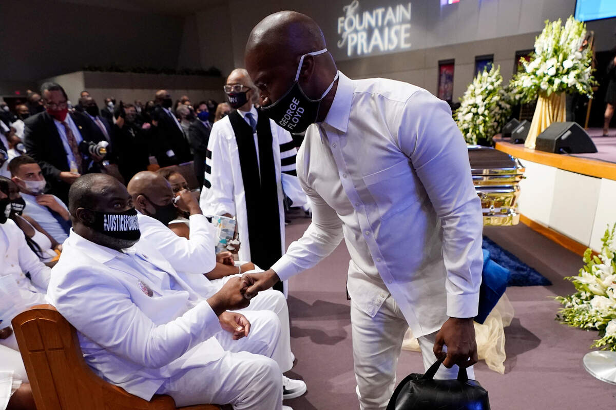 Actor Jamie Foxx, right, speaks with Rodney Floyd during the funeral service for George Floyd at The Fountain of Praise church Tuesday, June 9, 2020, in Houston. (AP Photo/David J. Phillip, Pool)