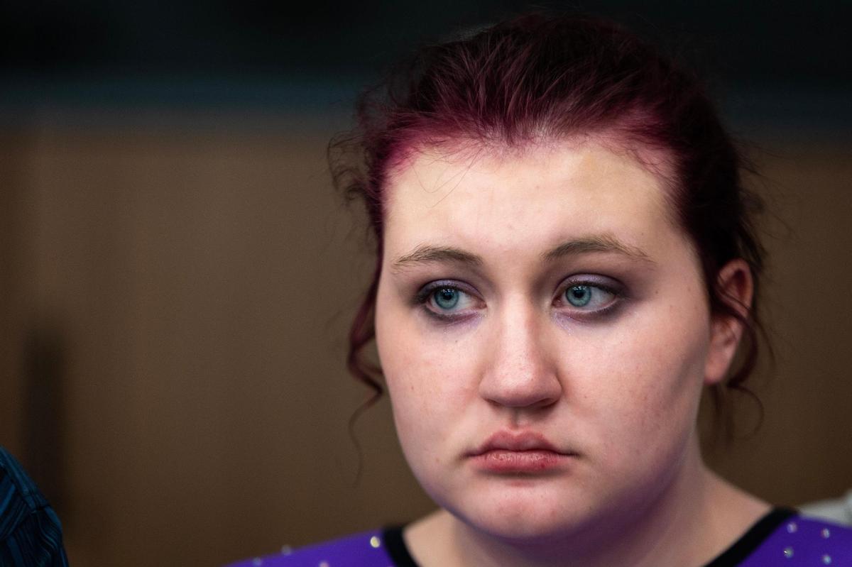Elaine Harkey, 16, sits with her parents at her dad’s office in downtown Oklahoma City, Okla. on Saturday, Feb. 18, 2023. Harkey was enrolled in a residential program for teenagers with autism at Fort Behavioral Health before it was abruptly shut down by the state of Texas last month.