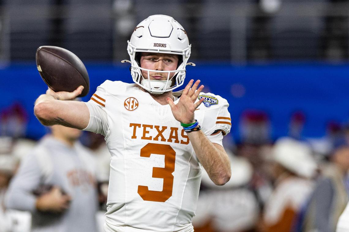 Texas quarterback Quinn Ewers (3) prepares to throw a pass in the first quarter of the College Football Playoff semifinal game between Ohio State and Texas at AT&T Stadium in Arlington on Friday, Jan. 10, 2025.