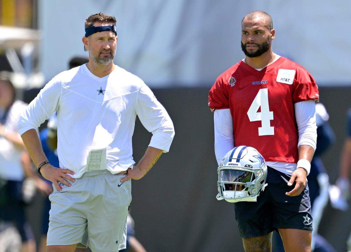 Dallas Cowboys quarterback Dak Prescott (4) talks with offensive coordinator Brian Schottenheimer during training camp July 26, 2023, in Oxnard, Calif.