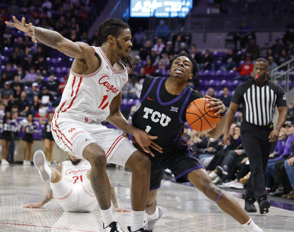 TCU guard Jayden Pierre (1) works out of the corner against Houston forward Joseph Tugler (11) during the first half of a NCAA basketball game between the University of Houston and TCU at Schollmaier Arena in Fort Worth, Texas, Wednesday Jan. 26, 2026