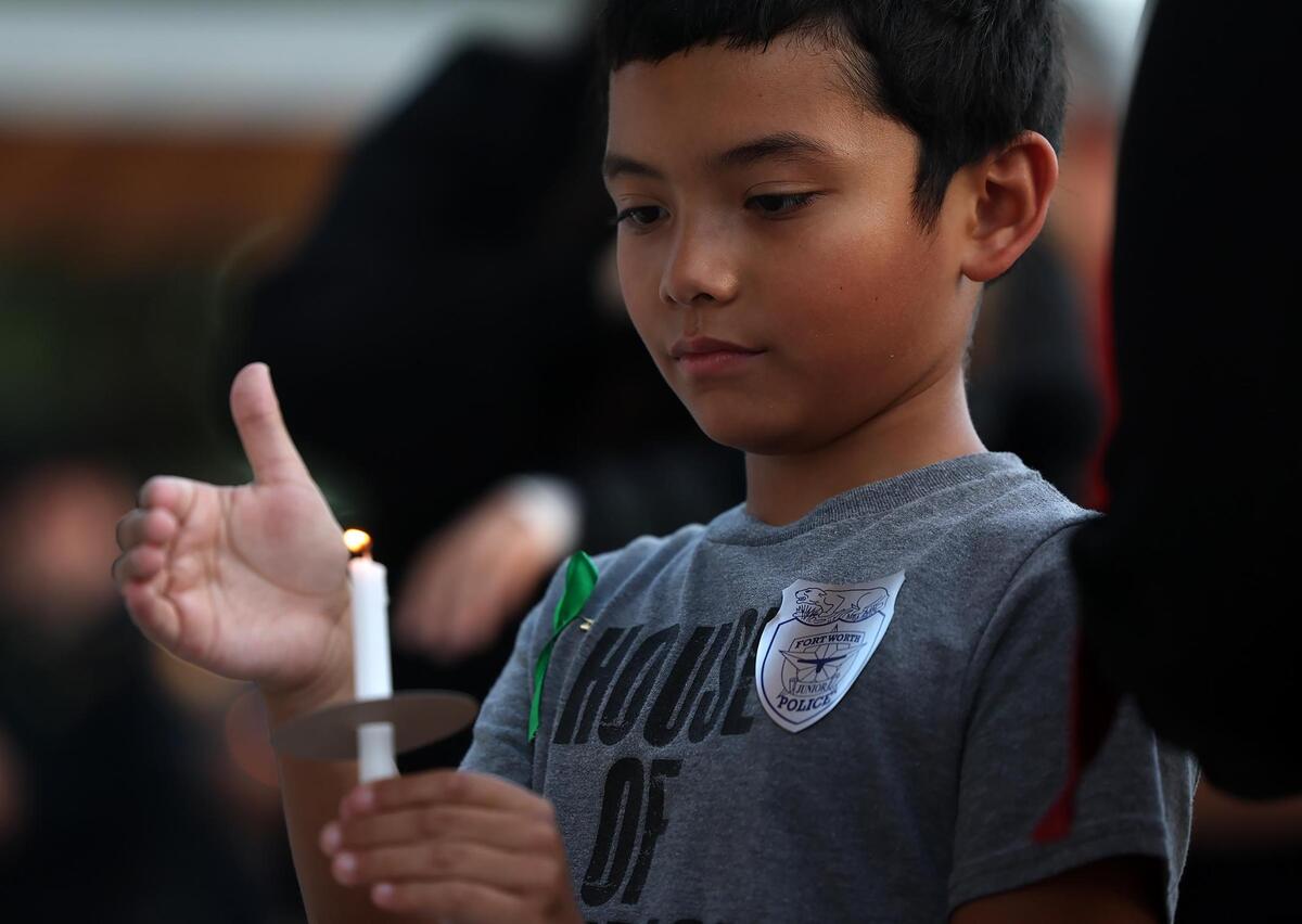 John Austin Giordano, 10, attends a candlelight vigil for the Hill Country flood victims with his family on Monday, July 14, 2025, at Fort Worth City Hall.