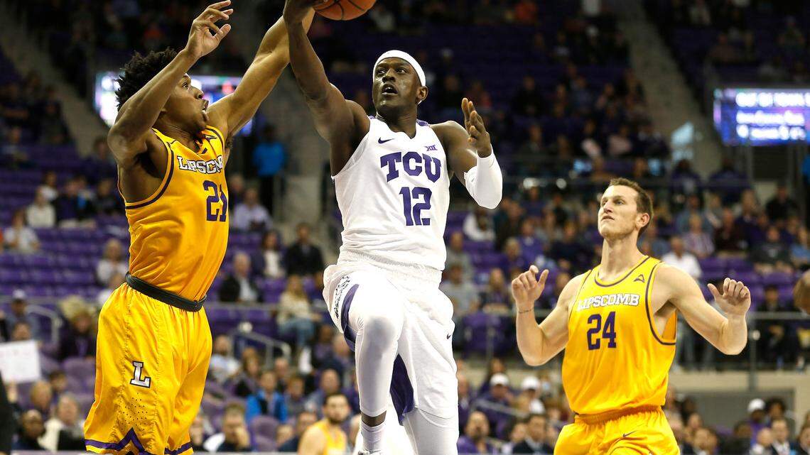 TCU forward Kouat Noi (12) drives past Lipscomb defenders Kenny Cooper (21) and Garrison Mathews (24) during the first half Tuesday in Fort Worth.