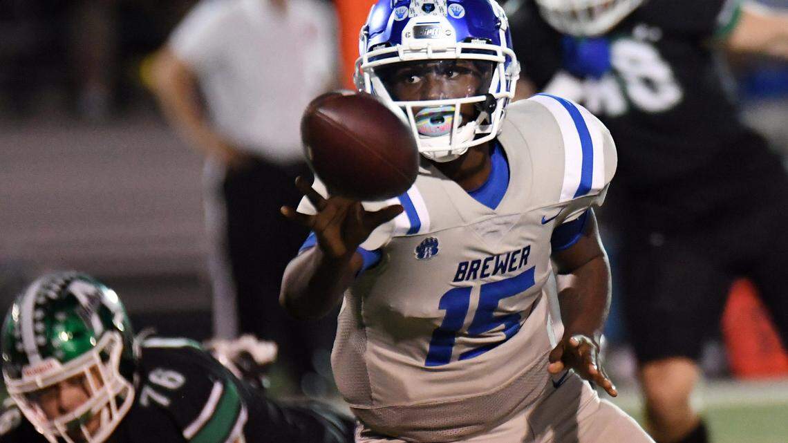 Brewer quarterback Jaylen Spriggs, center, pitches the ball back for a running back in the first quarter of their district 3-5A Division 1 football game against Azle Friday, October 22, 2021 at Hornet Stadium in Azle, Texas. Special/Bob Haynes