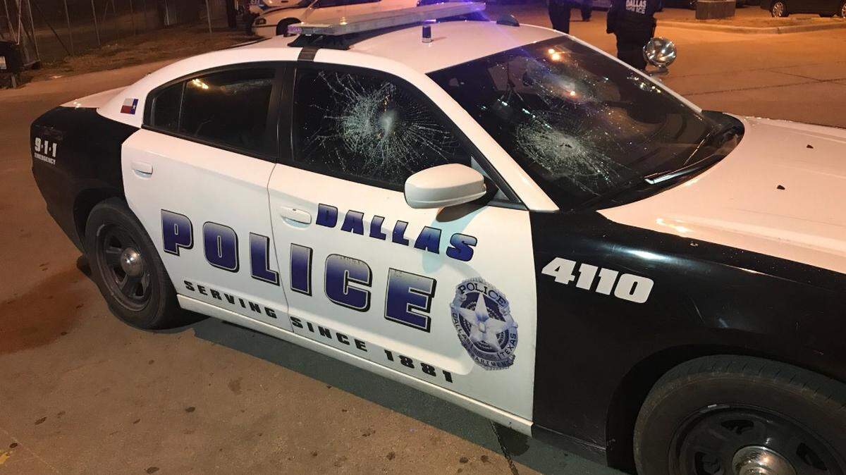 The Dallas Police Association tweeted two photos on Sunday, Feb. 3, showing two of the cars, one a black and white 4-door sedan and a white SUV, with the front and side windows with huge circular cracks.