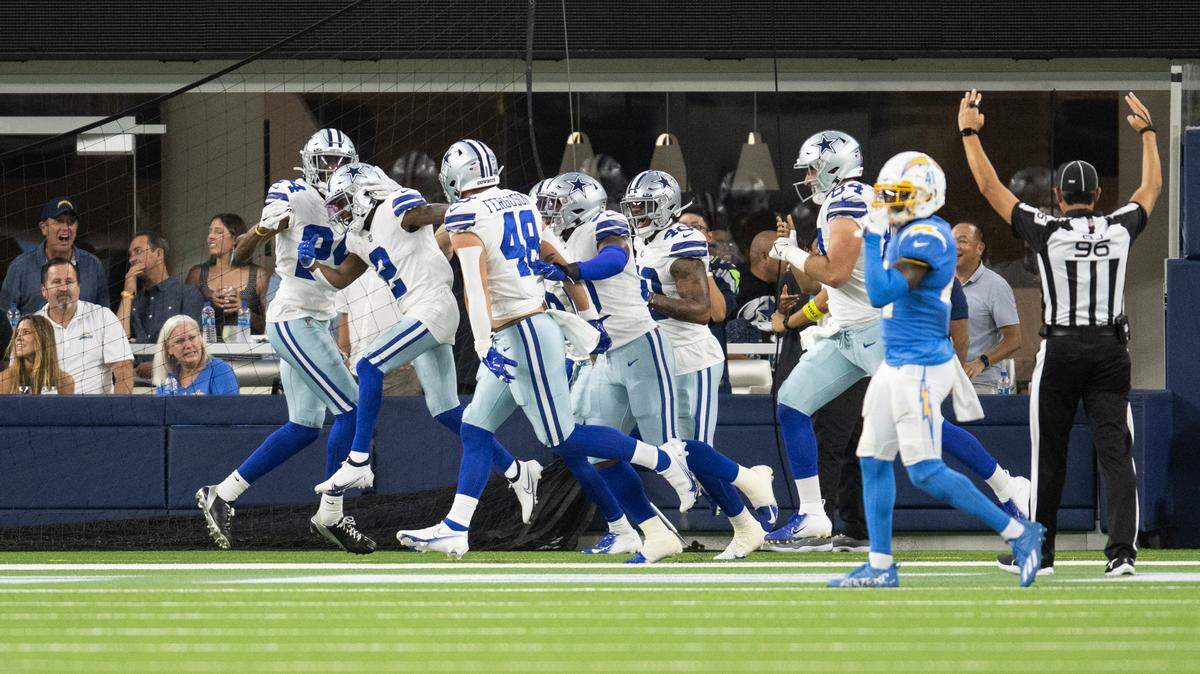 Dallas Cowboys players celebrate with KaVontae Turpin (2) after he scores on his second returnof the game against the Chargers in Los Angeles on Saturday.
