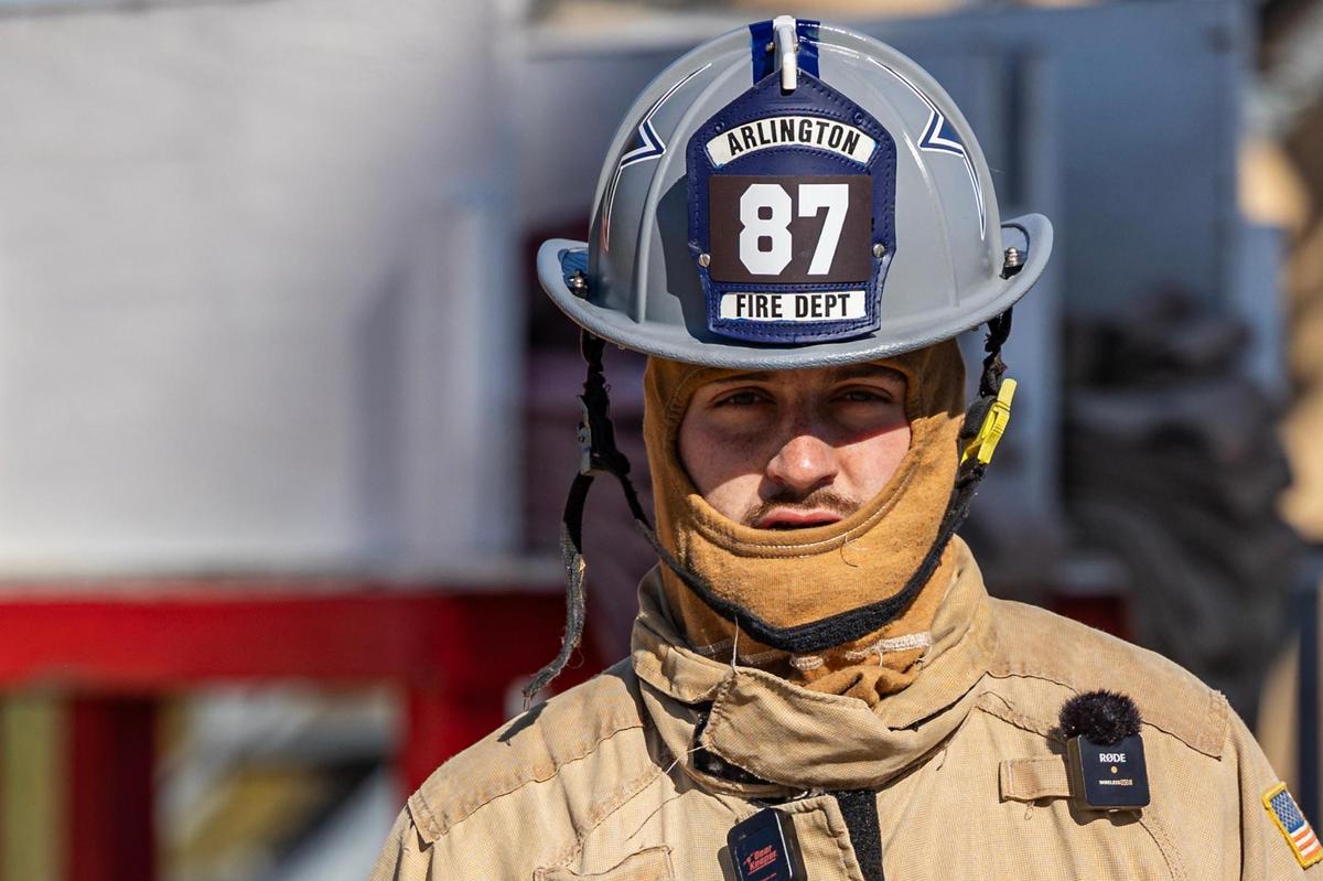 Dallas Cowboys tight end Jake Ferguson wears his custom made firefighter helmet during a Turkey Fryer Fire Safety demonstration at the Arlington Fire Department Training Facility Station 14 in Arlington on Tuesday, Nov. 14, 2024.