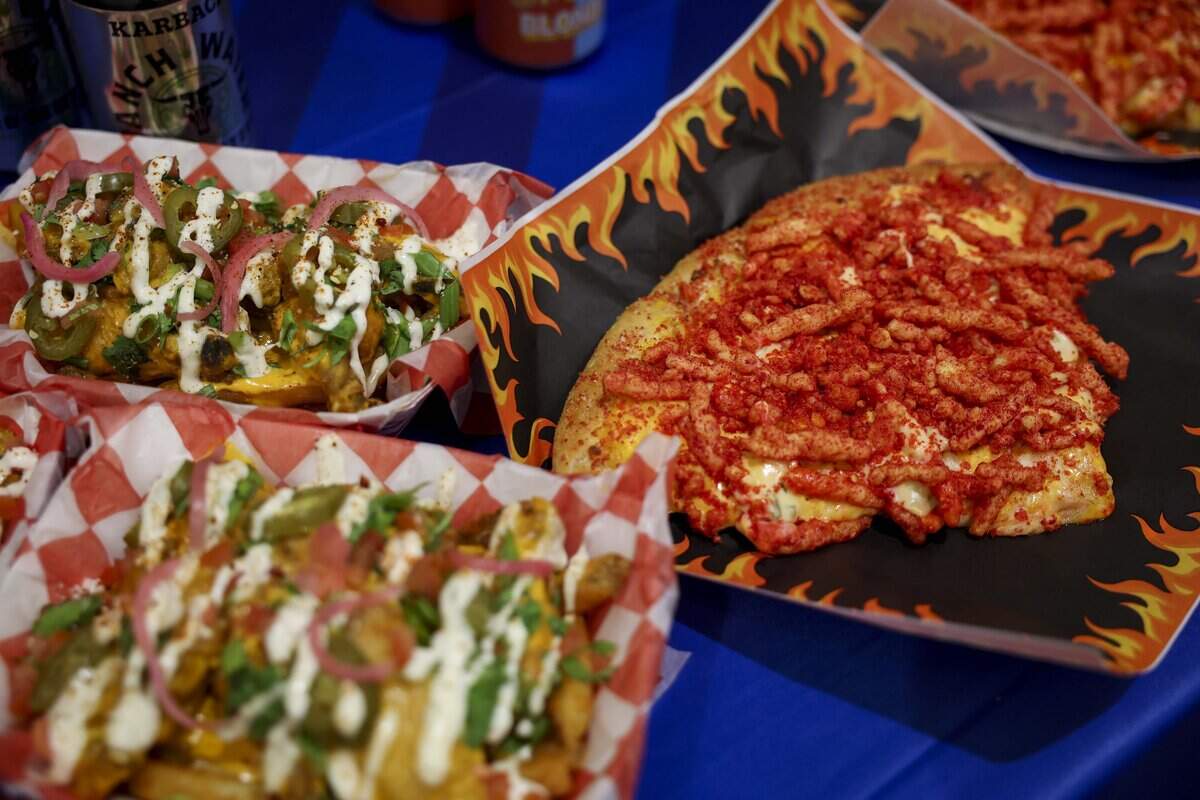 Finalist, the Flamin' Crunch Pizza, is a hand tossed crust topped with a jalapeño cheddar queso base, mozzarella, cheddar cheese, Flamin' Hot Cheetos, jalapeño queso blanco and house-made buffalo buttermilk ranch dressing during the Big Tex Choice Awards on Tuesday, Aug. 18, 2026 in Dallas.