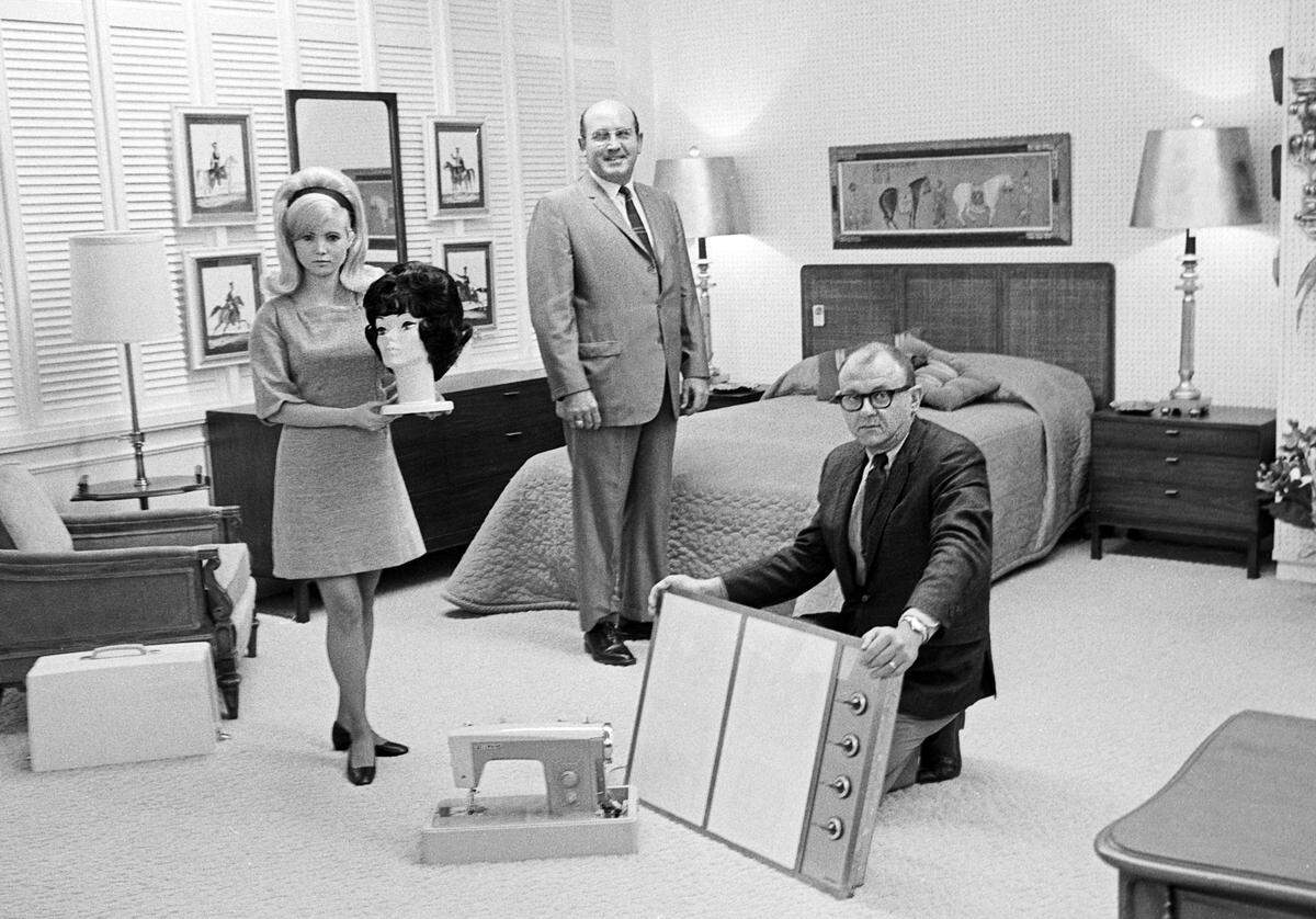 Pictured are some of the prizes awarded to the grand prize winner of the 1968 Star-Telegram Recipe Contest. Mrs. Roy L. Woods of Marsel Wig Fashions displays a wig; Dick Fillingim of Guild Galleries stands beside the bedroom suite; and I. L. (Buddy) Freed of Freed Appliances holds a Nelco sewing machine ensemble.  
