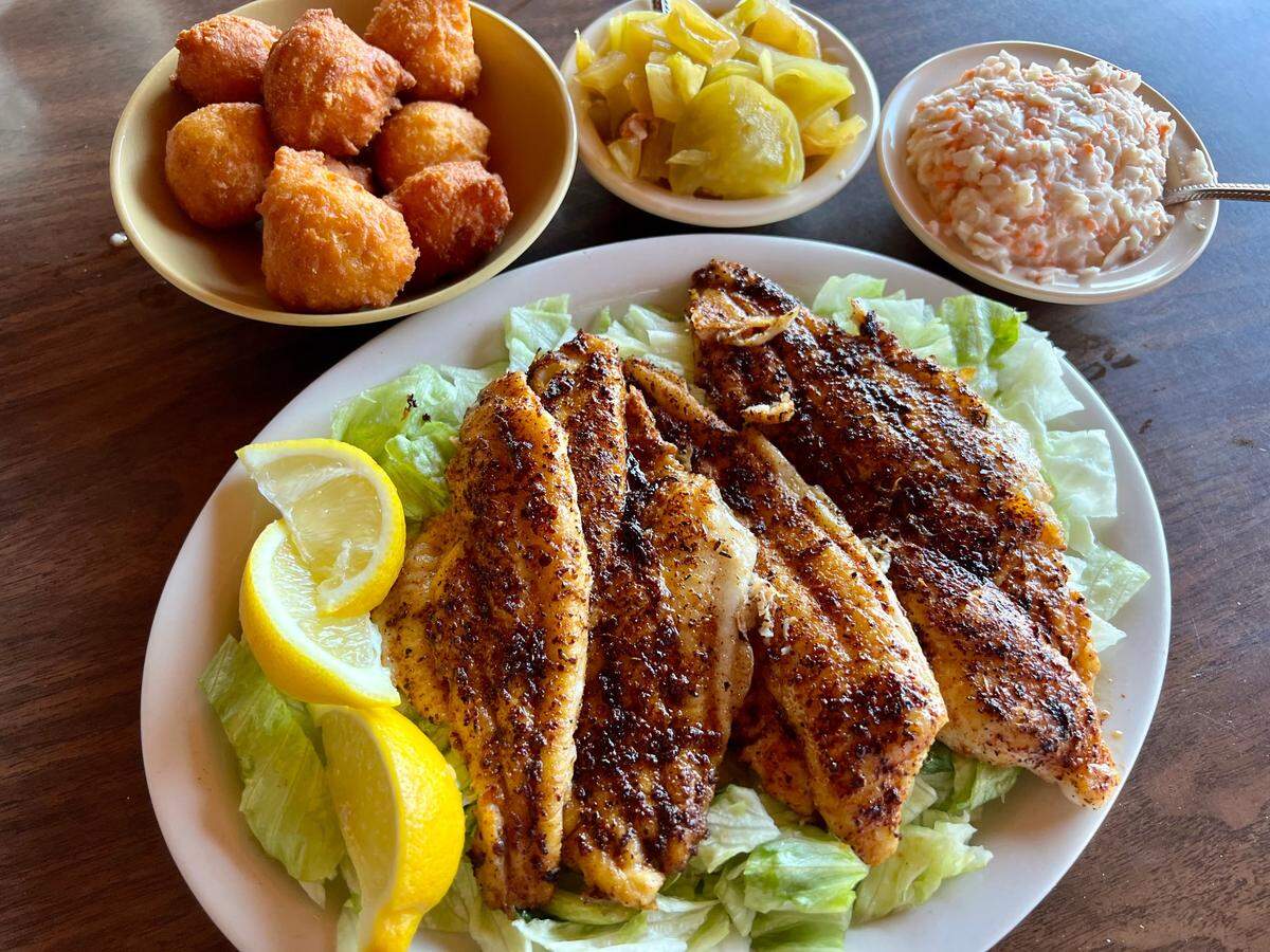 Seasoned, grilled catfish fillets with hush puppies, green tomato relish and cole slaw at McGehee’s.