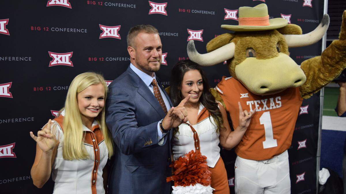 Texas coach Tom Herman poses with the Longhorns mascot and cheerleaders during Big 12 Media Days at The Ford Center at The Star in Frisco, Texas, on Tuesday, July 17.