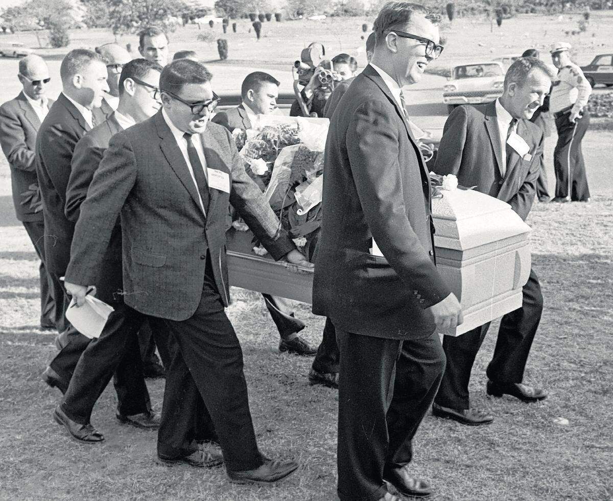 The late Star-Telegram columnist Jon McConal, center on the far side of the casket, was among reporters who became Lee Harvey Oswald’s pallbearers Nov. 25, 1963, when Fort Worth police asked for help. The “mystery pallbearer,” the man obsuced in front of McConal, has never been identified. Preston McGraw of United Press International is in front of them. On the near side, reporters include Jerry Flemmons of the Star-Telegram, second from left, and Mike Cochran of The Associated Press, fourth from left. The identity of the man between Cochran and Flemmons is now in dispute. He has always been identified as Star-Telegram reporter Ed Horn, but family members believe it is WBAP/820 AM reporter Bob Dickson. (Gene Gordon)