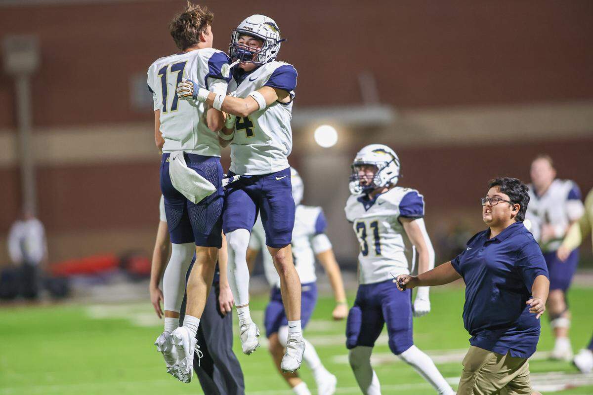 Keller players rush the field and celebrate after the final buzzer at Northwest ISD Stadium in Justin, Texas, Friday, Nov. 7, 2025.
