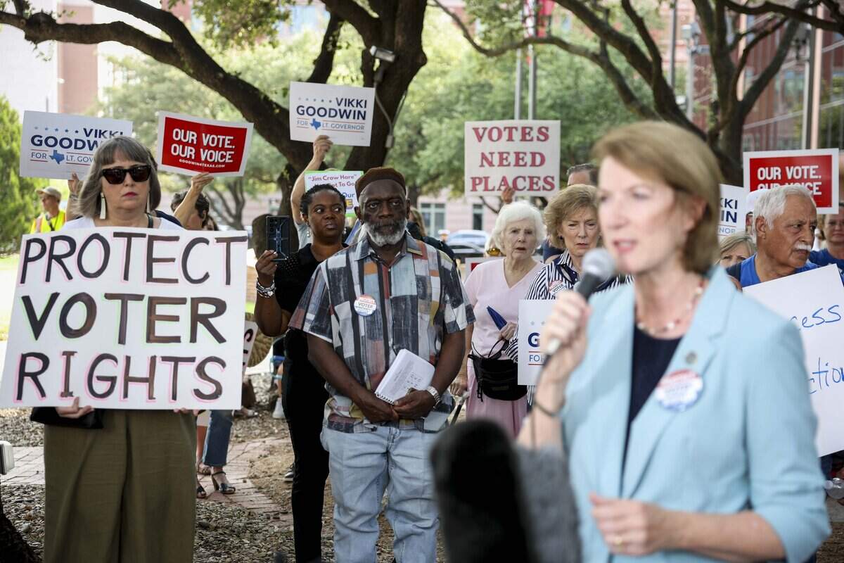 People gather outside of the Tarrant County Commissioners Court to protest the proposed cut of polling places on Tuesday, Aug. 4, 2026 in Fort Worth.