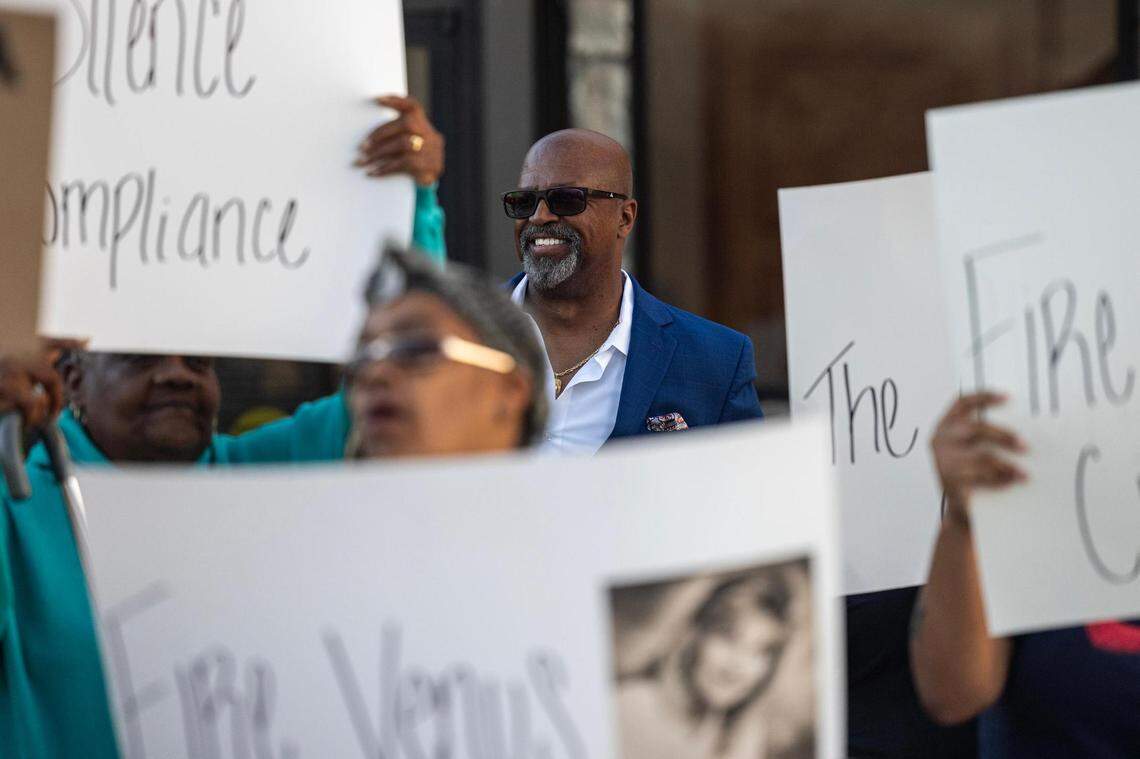 Former Forest Hill Police Chief Eddie Burns Sr., who was fired in February after being on medical leave, smiles as he looks on at the dozens of residents rallying and holding signs in support of him in front of Forest Hill City Hall on March 1, 2024.