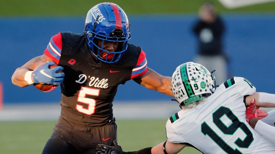 Duncanville running back Malachi Medlock stiff arms Southlake defensive back Logan Anderson (19) to gain yards during a high school Class 6A Division 1 semifinal playoff game at McKinney ISD Stadium in McKinney, Texas, Saturday, Dec. 11, 2021. Duncanville led Southlake Carroll 21-3 at the half.